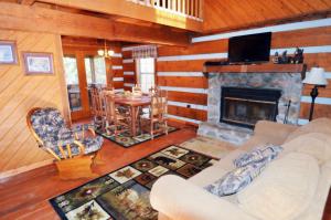 a living room with a couch and a fireplace at Emerald Woods in Pigeon Forge