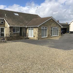 a house with a gravel driveway in front of it at Deneview in Consett