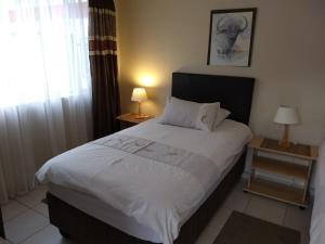 Postel nebo postele na pokoji v ubytování Tourmaline Guest House