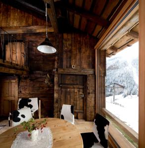 a dining room with a table and chairs in a barn at Ögghof 221 in Kaunertal
