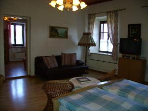 a living room with a couch and a table at Gästehaus Brückler in Jennersdorf