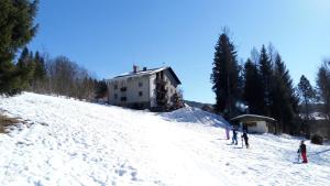 a group of people skiing down a snow covered slope at Penzion Diana in Železná Ruda