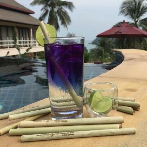 a glass of water and a glass of lime and a drink at Koh Phangan Pavilions Serviced Apartments in Thong Nai Pan Noi