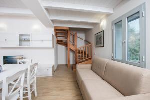 a living room with a couch and a table at Appartamento Costa del Sole in Pomonte