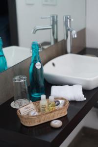 a bathroom counter with a bottle and a sink at Casa Q in Quito