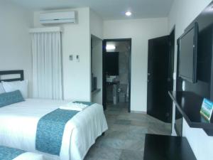 En eller flere senger på et rom på Hotel Andiroba Palace