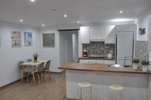 a kitchen and dining room with a table and chairs at La Casita De Angela in Frigiliana
