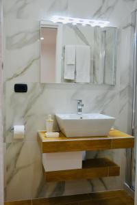 a bathroom with a sink and a mirror at Nea Loft in Naples