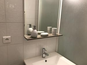 un baño con lavabo y espejo en Appartement Rue Victor Hugo - Port de la Houle, en Cancale 36 fotos más