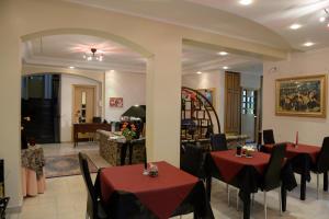 a restaurant with tables and chairs and a living room at Villa Eden in Corbara