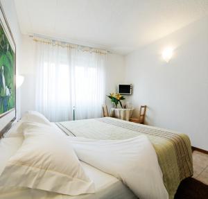 A bed or beds in a room at Antico Albergo Madonna