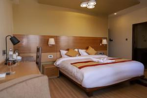 a bedroom with a large bed and a desk at Retro Hotel and Spa in Kathmandu +45 photos