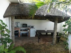 a patio with a table and a kitchen in a house at Lighthouse Accommodation in East London