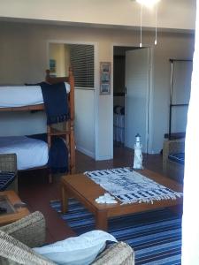 a living room with bunk beds and a coffee table at Lighthouse Accommodation in East London