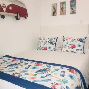 a bedroom with a bed with a toy car on it at Cantinho das Flores I in Nazaré