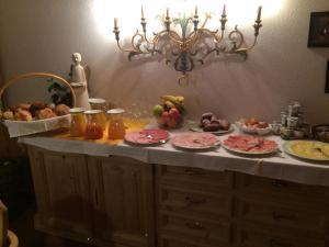a counter with plates of food on top of it at Hotel Gomagoierhof in Stelvio