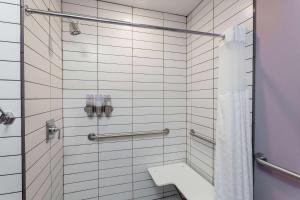 a bathroom with a shower with a toilet and a sink at Hotel at the Lafayette Trademark Collection by Wyndham in Buffalo