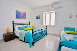 a bedroom with two beds and a window at Il Veliero Blu Lipari Centro - Guest House in Lipari +84 photos
