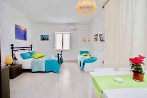 a bedroom with two beds and a couch at Il Veliero Blu B&B Lipari Centro in Lipari