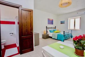 a room with a bedroom with a bed and a bathroom at Il Veliero Blu B&B Lipari Centro in Lipari