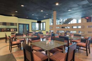 a dining room with tables and chairs in a restaurant at Wyndham Garden Midland in Midland