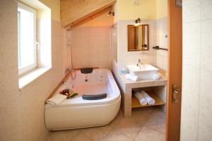 a bathroom with a large tub and a sink at Authentic Luxury Rooms in Split +39 photos