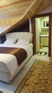 a bedroom with a large bed and a rug at Ozbek Suite Hotel in Uzungol