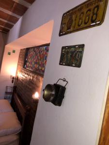 a wall with a clock and some pictures on it at Departamento Reconquista in Villa María