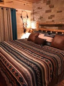 a large bed in a room with a stone wall at DreamCatcher Downtown Gatlinburg in Gatlinburg