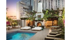 a building with a swimming pool in a city at Hotel Figueroa, Unbound Collection by Hyatt in Los Angeles