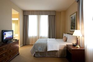 a hotel room with a bed and a television at Bolger Hotel and Conference Center in Potomac