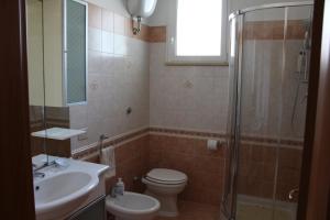a bathroom with a toilet and a sink and a shower at Mary Casa Vacanza in Monterotondo +9 photos