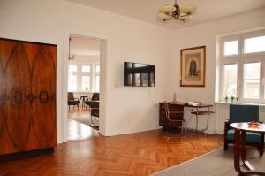 a living room with a table and a wooden door at Apartmán u Masaryka in Hodonín