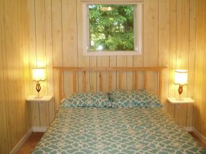 Säng eller sängar i ett rum på Bubbling Brook Cottages