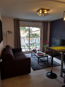 a living room with a couch and a table at Le Belouga in Pornichet