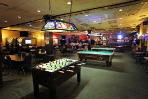 a room with a pool table and a bar at National 9 Inn Gillette in Gillette