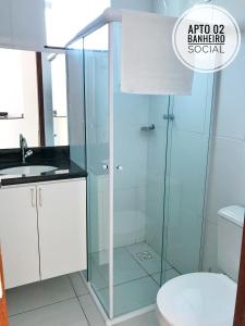 a bathroom with a shower with a toilet and a sink at Mar de Boipeba in Ilha de Boipeba
