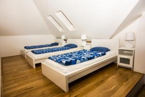 
a bed room with two beds and a desk at Hostel One Míru in Prague
