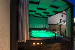 a green tub in a room with a window at Apartment L Rovinj with Private Jacuzzi in Rovinj