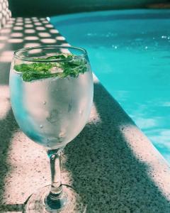 un verre d'eau assis à côté d'une piscine dans l'établissement Rans Chalets, à Taif