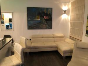 a living room with a white couch and a table at Apartment Amorino in Opatija