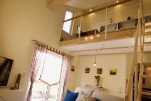 a room with a loft bed and a couch at Ferienwohnung Maurer in Hasborn-Dautweiler