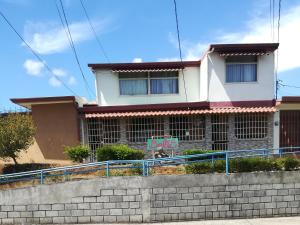 a house with a sign in front of it at Belis in Alajuela