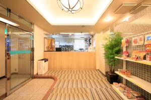 a hallway of a store with a glass door at Ueno Station Hostel Oriental Ⅱ(Men Only) in Tokyo