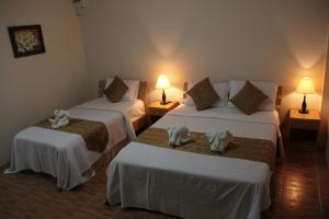 a hotel room with two beds with towels on them at Groovy Bungalows in Ao Nang Beach +11 photos