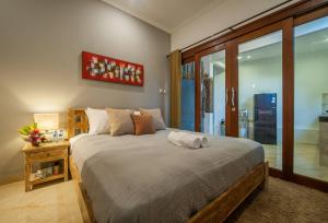a bedroom with a large bed in a room at Umah DiTebe Canggu in Canggu