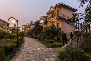 a cobblestone street in a city with houses at Hotel Seven Star in Sauraha