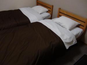 Postel nebo postele na pokoji v ubytování Hotel New Kotobuki