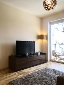 A television and/or entertainment centre at ClickTheFlat Artistic Estate Apartment