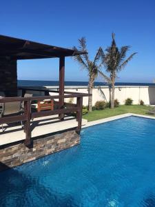 a swimming pool with a view of the ocean at Altara in Boca del Río